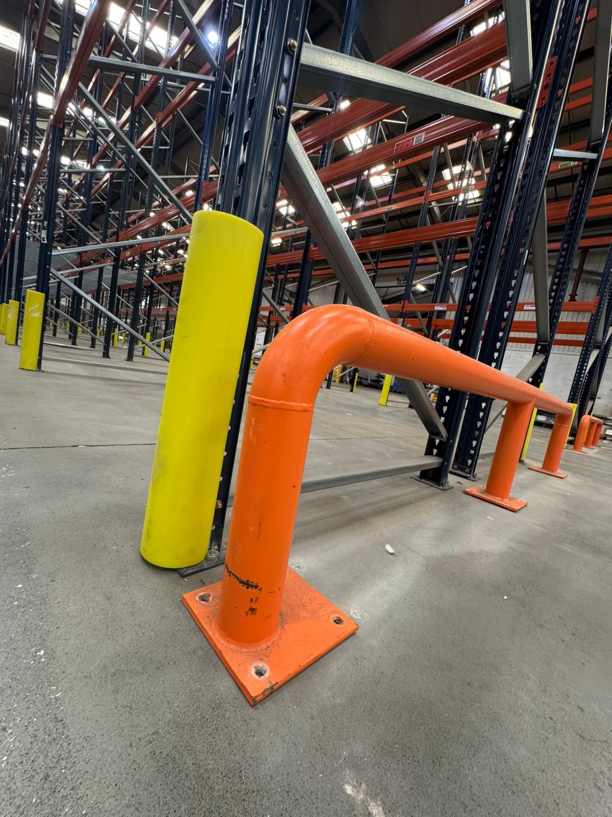 Wire anti-collapse mesh panel behind blue and orange racking